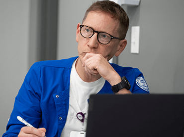 Image of student watching presentation.